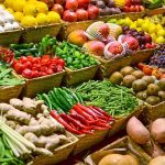 Everyday Fruit to Eat in 2026 to Reduce Inflammation A vibrant display of assorted fruits and vegetables in baskets at a market