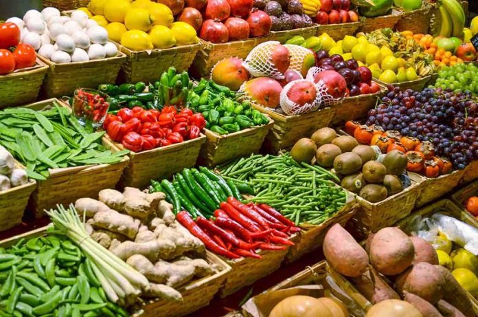 shutterstock_130707287.jpg A vibrant display of assorted fruits and vegetables in baskets at a market