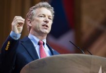 Rand Paul SLAMS Pentagon Pete – Incompetence of Lies? Man in a suit delivering a speech at a podium