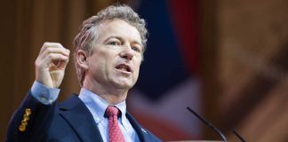 Man in a suit delivering a speech at a podium