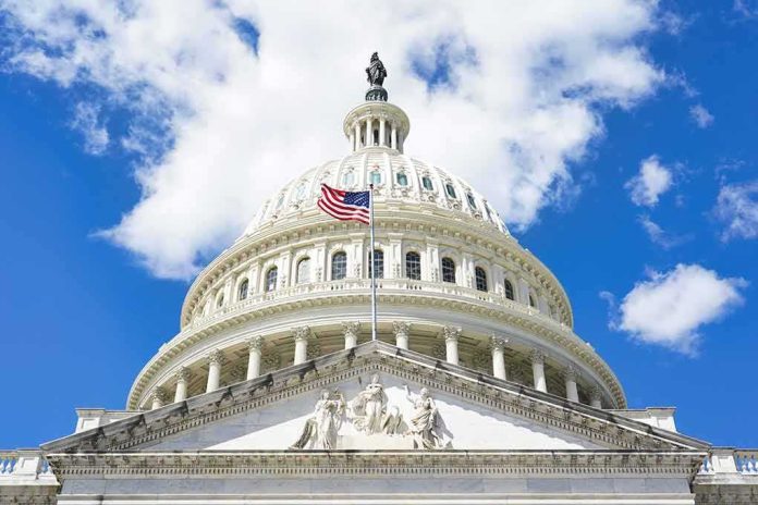shutterstock_2465401345.jpg The U.S. Capitol building with an American flag flying in front against a blue sky