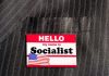Hello my name is Socialist name tag on suit.