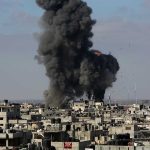 Large explosion over a crowded urban area.