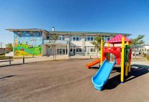Colorful playground slide in front of a building.