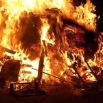 Blazing Inferno KILLS 40 – Shocking Cause Revealed A large fire engulfing debris at night