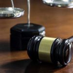 Obama Judge FREES 4 Murderers and Child Predators! Gavel and scales of justice on wooden table.