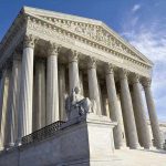 SCOTUS Takes Case, 125-Year Law Under Threat Supreme Court building with statue and columns.