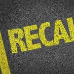 Yellow RECALL text on asphalt background.