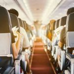 Airlines ROLL OUT New Rule – Crackdown Shakes Flights! Passengers seated inside an airplane cabin.