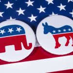 Longstanding GOP Seat Flips – Huge Wake Up Call! Republican elephant and Democrat donkey on American flag.