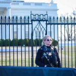 Secret Service agent stands guard outside the White House.
