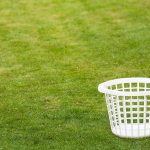 Looney Liberal Declares LAWNS Racist An empty white laundry basket placed on green grass