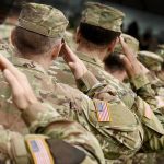 International Fugitive ARRESTED in U.S. Boot Camp! Soldiers in camouflage uniforms saluting in formation outdoors