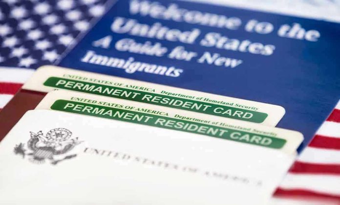 232231384 Permanent resident cards with welcome guide and flag.