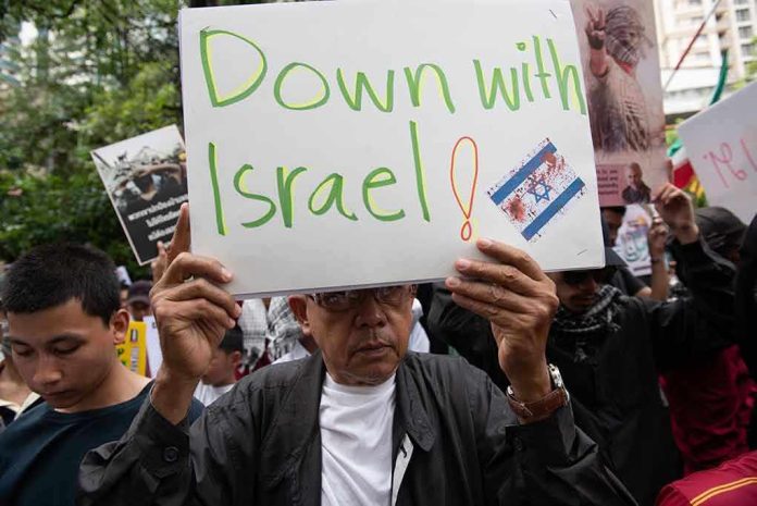 2378341151 Person holding Down with Israel sign at protest.