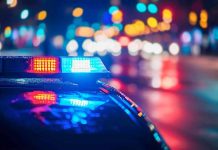 Police car with flashing lights at night.