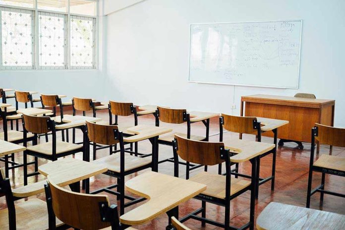 612777398 Empty classroom with desks, chairs, and whiteboard.