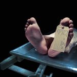 SICKO Breaks Into Morgue – Commits The UNTHINKABLE! Feet of a deceased person on a coroners table with an identification tag