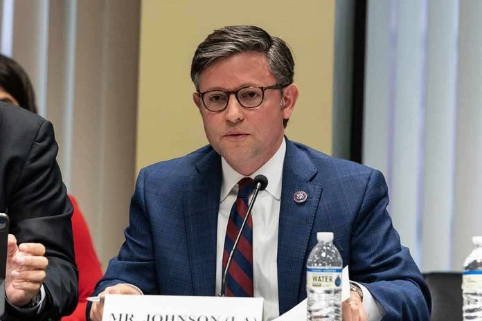 shutterstock_2290525913 A public official speaking at a meeting with a nameplate in front of him