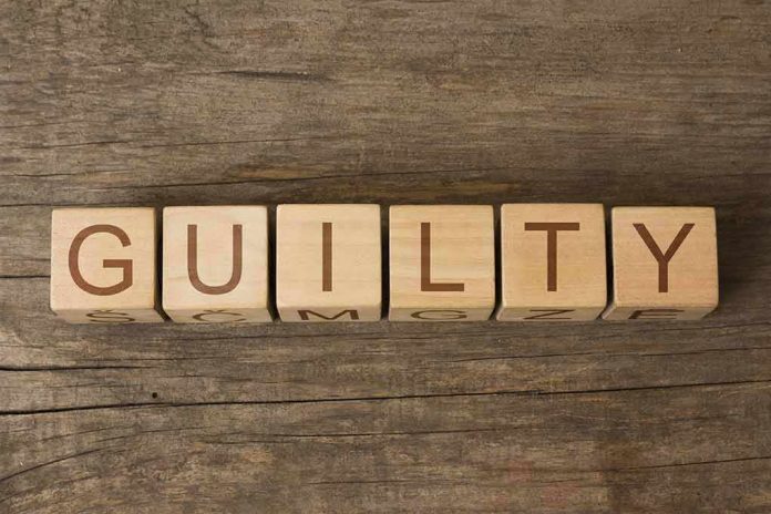 Wooden blocks arranged to spell 'GUILTY' on a wooden surface