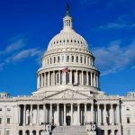 Jewish Rep BANNED From Local Cafe – DOJ Steps In US Capitol Building against blue sky.