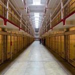 Shock Verdict: Ex-President Sentenced to 30-Years! Long hallway with prison cells on both sides.