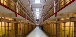 Shock Verdict: Ex-President Sentenced to 30-Years! Long hallway with prison cells on both sides.