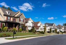 A row of modern suburban houses under a clear blue sky
