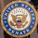 United States Senate seal at a podium