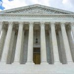 Justice Barrett BETRAYS Trump Again, 5-4 Vote! Building with columns under a cloudy sky.