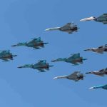 A formation of military jet fighters flying in a clear blue sky