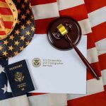 U.S. passport, gavel, and USCIS document on American flag