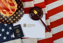 U.S. passport, gavel, and USCIS document on American flag