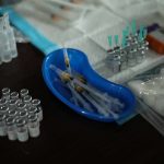 Medical syringes and vials arranged on a table