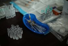 Medical syringes and vials arranged on a table
