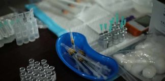 Medical syringes and vials arranged on a table