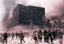 Emergency responders and civilians amidst debris at a disaster site