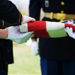 Pentagon Identifies Missing Soldier Killed In Terrorist Attack Military personnel folding a flag during a ceremonial event
