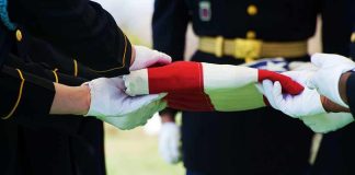 Pentagon Identifies Missing Soldier Killed In Terrorist Attack Military personnel folding a flag during a ceremonial event