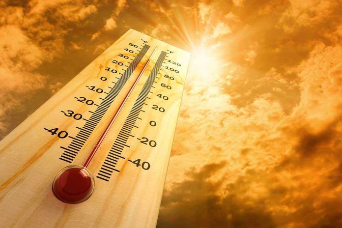 shutterstock_80404600 A thermometer displaying temperature against a sunset sky