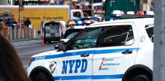 NYPD police car on a city street scene.