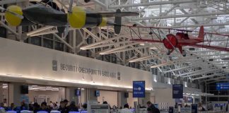 What Travelers Did To Airport Lounge is GROSS airport security checkpoint with passengers and hanging vintage airplanes