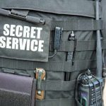 Tactical vest with Secret Service patch and gear