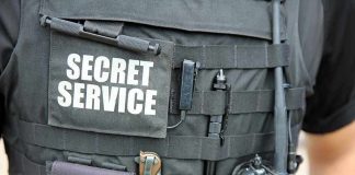 Tactical vest with Secret Service patch and gear