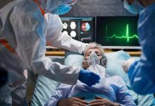 Patient on hospital bed with oxygen mask