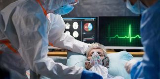 Patient on hospital bed with oxygen mask
