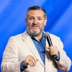 Ted Cruz Launches 2028 Bid After Fight with Vance man in beige blazer speaking into a microphone