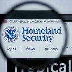 HSI Agent Indicted On Child Rape Magnifying glass showing Homeland Security website.