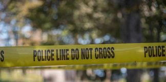 Stand-Your-Ground Shields Female Shooter yellow police tape cordoning off an outdoor area