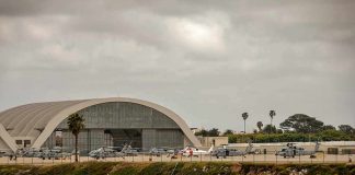 airport hangar with helicopters near a shoreline
